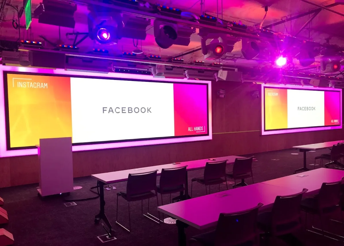 Meta company all-hands stage with large LED walls and event lighting
